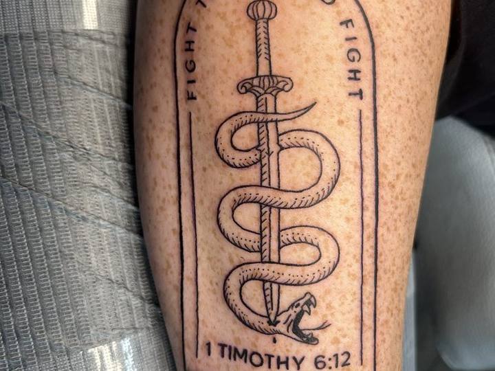 Fine line dagger and snake on a forearm