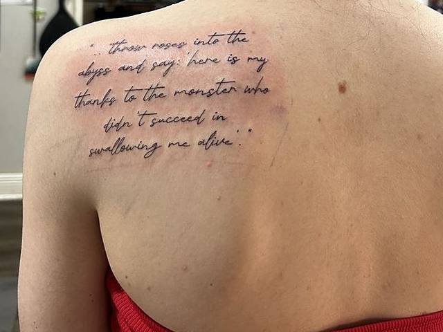 Script lettering across a shoulder blade
